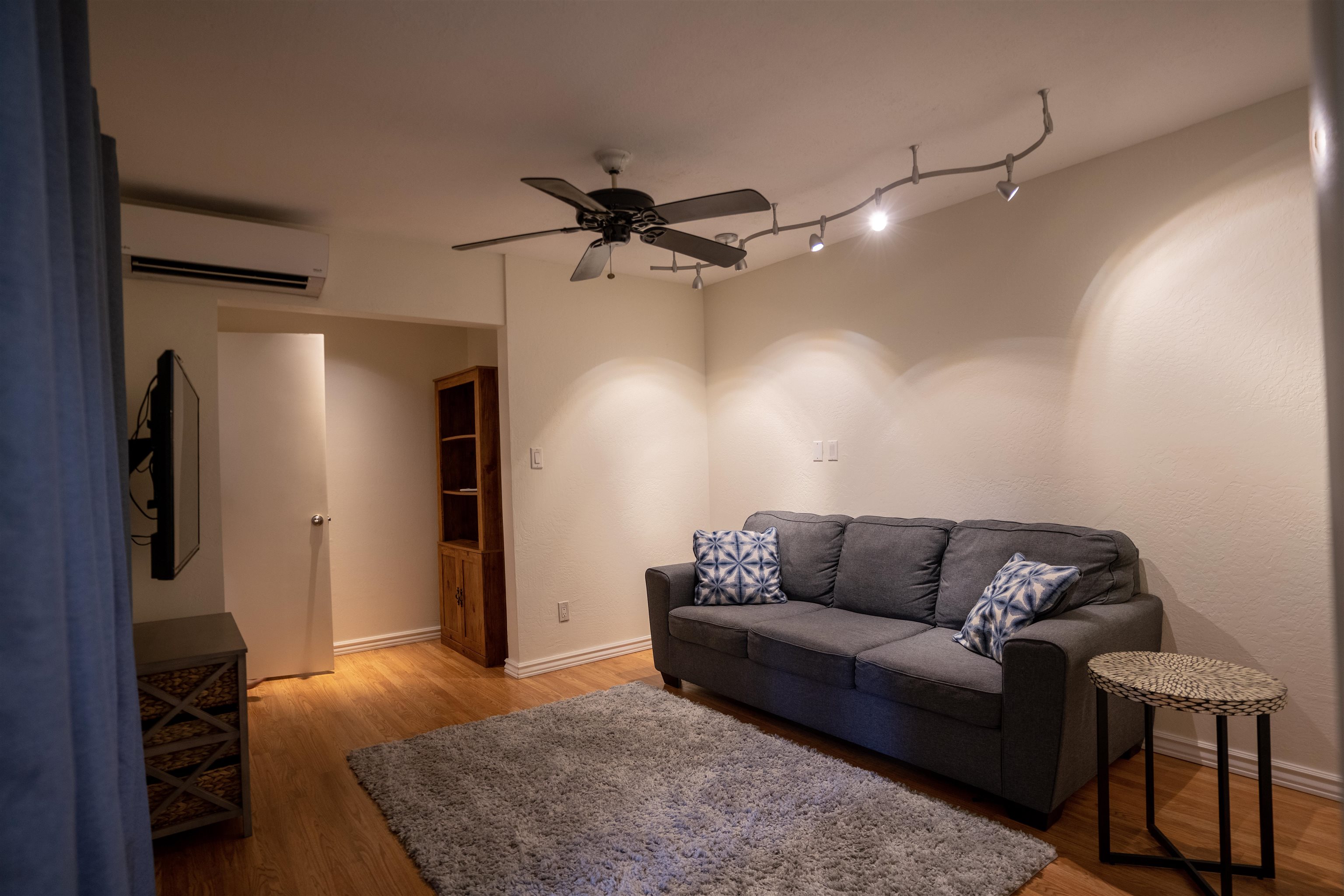 107 Mehani Place Kihei, HI 96753 - Photo 18 of 30 a living room with furniture and a flat screen tv