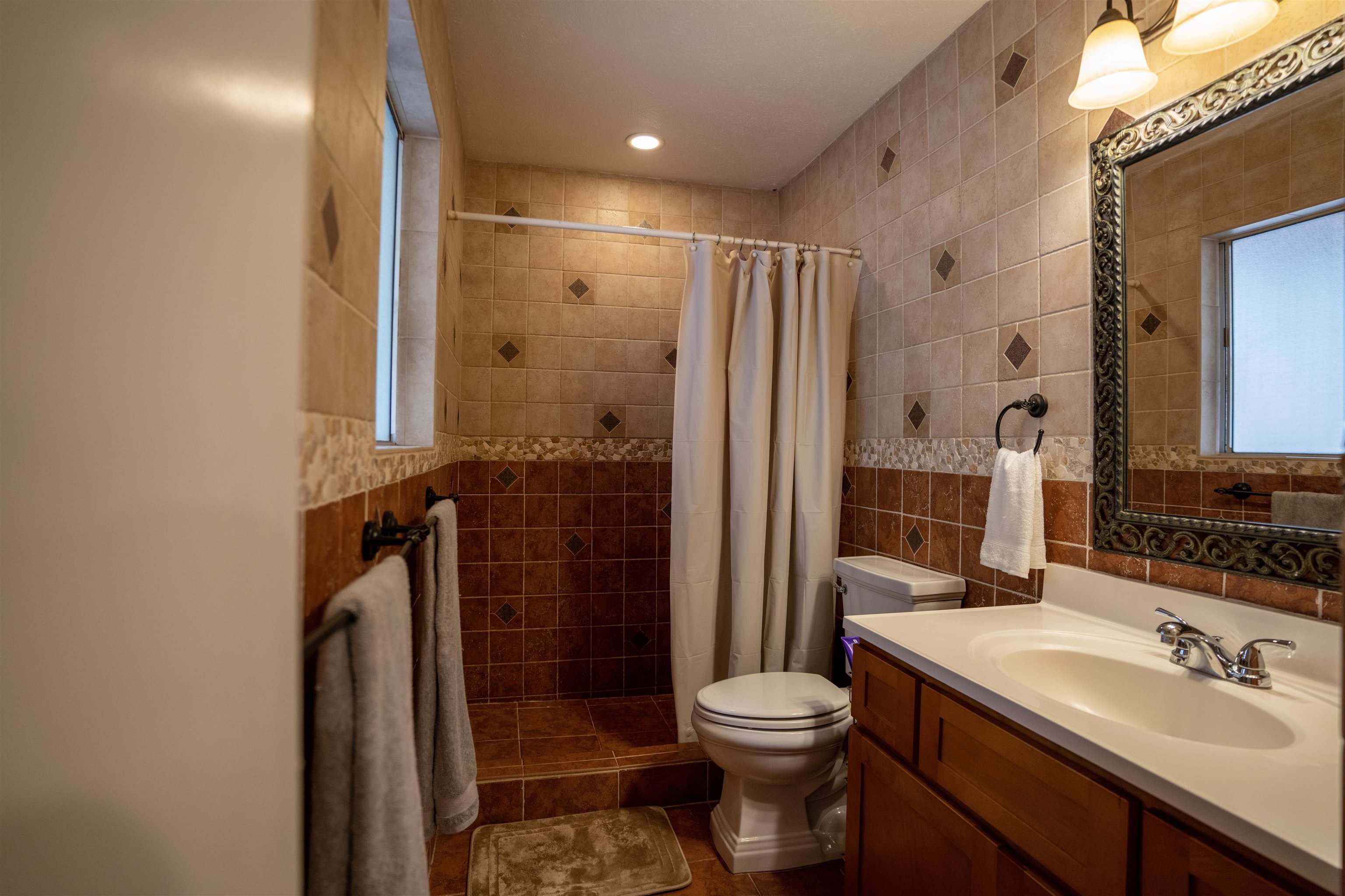 107 Mehani Place Kihei, HI 96753 - Photo 21 of 30 a bathroom with a sink a toilet and shower
