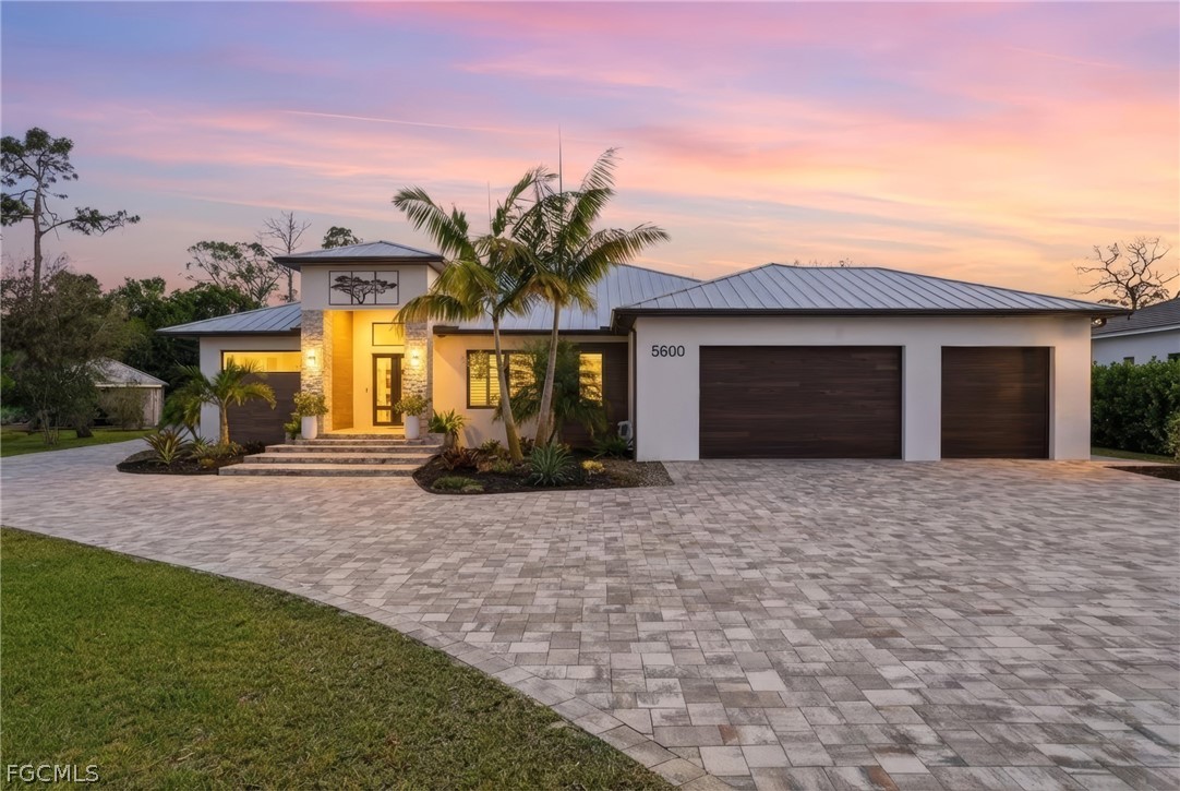 5600 Briarcliff Road Fort Myers, FL 33912 - Photo 1 of 50 a front view of a house with a yard and garage