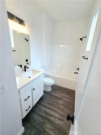 a bathroom with a double vanity sink mirror and toilet