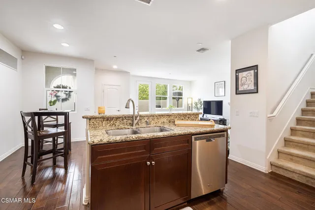 a kitchen with stainless steel appliances granite countertop a stove and a sink