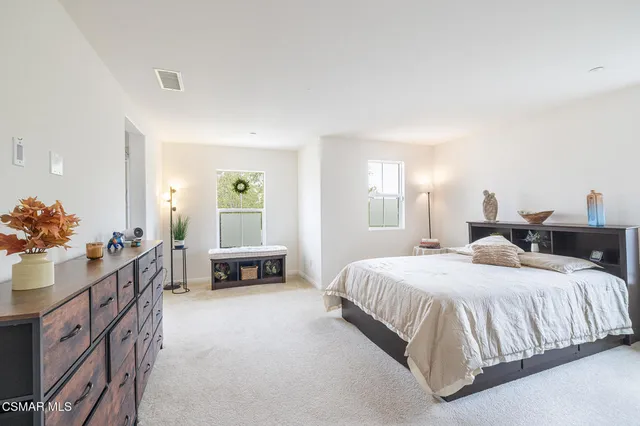 a bedroom with a bed and a couch