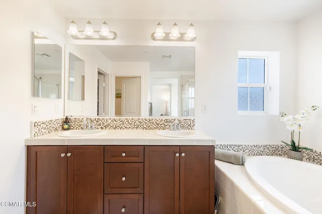 a bathroom with a granite countertop sink mirror and a