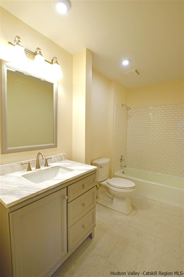 47 Roxanne Boulevard Highland, NY 12528 - Photo 15 of 24 a bathroom with a toilet a sink and mirror