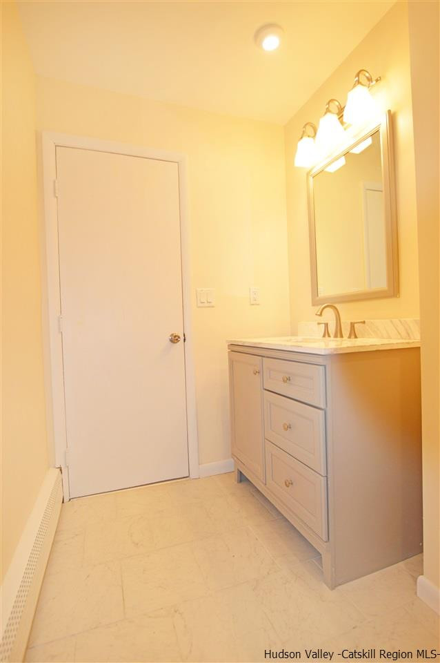47 Roxanne Boulevard Highland, NY 12528 - Photo 16 of 24 a bathroom with a double vanity sink and a mirror