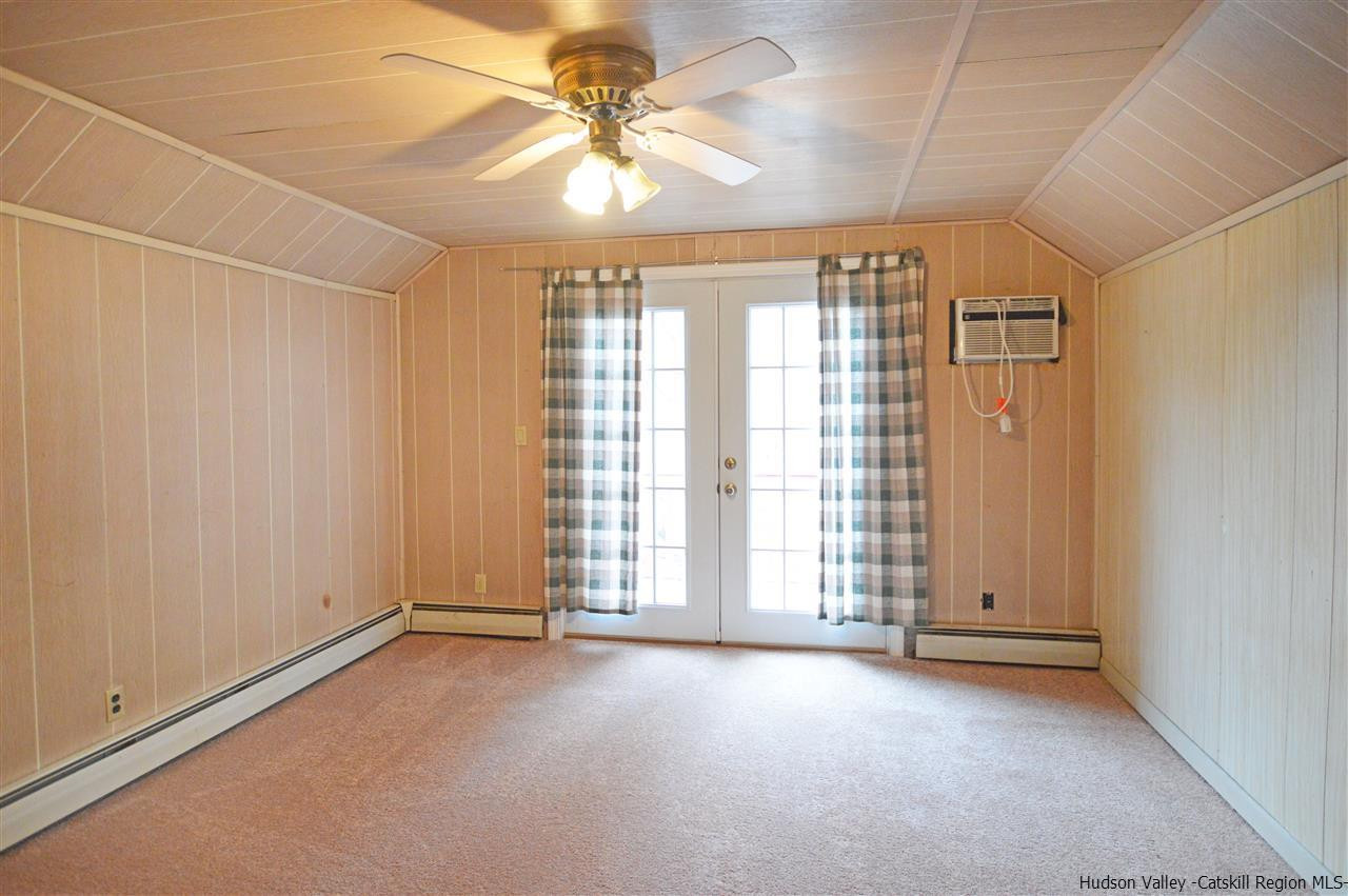47 Roxanne Boulevard Highland, NY 12528 - Photo 18 of 24 an empty room with chandelier fan and windows