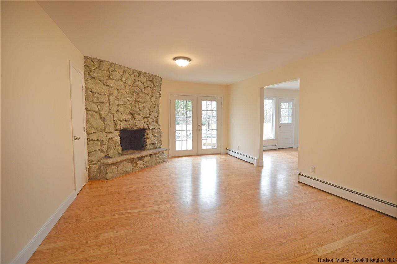 47 Roxanne Boulevard Highland, NY 12528 - Photo 2 of 24 a view of an empty room with window and wooden floor
