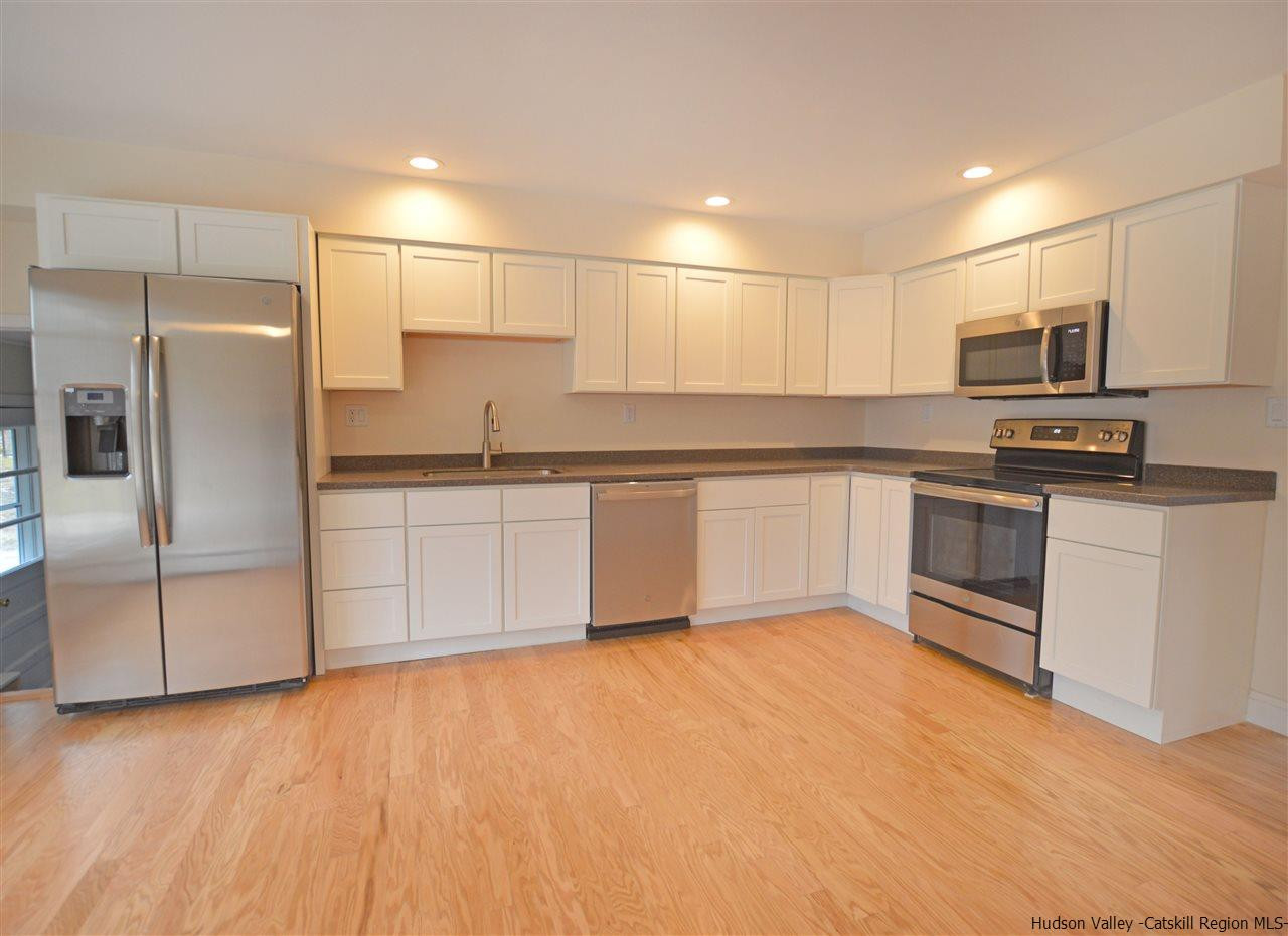 47 Roxanne Boulevard Highland, NY 12528 - Photo 4 of 24 a kitchen with stainless steel appliances granite countertop a refrigerator sink and microwave