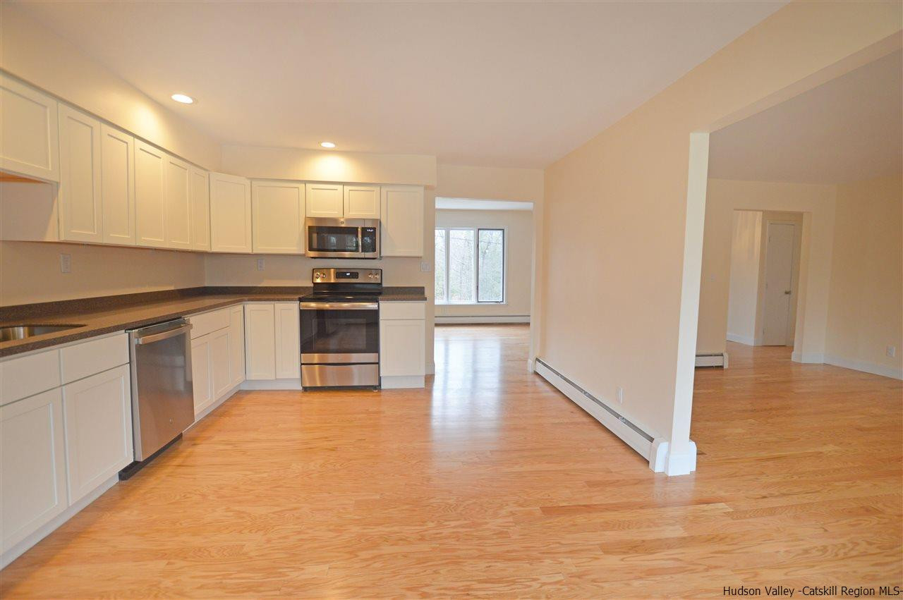 47 Roxanne Boulevard Highland, NY 12528 - Photo 6 of 24 a kitchen with granite countertop a stove top oven and cabinets