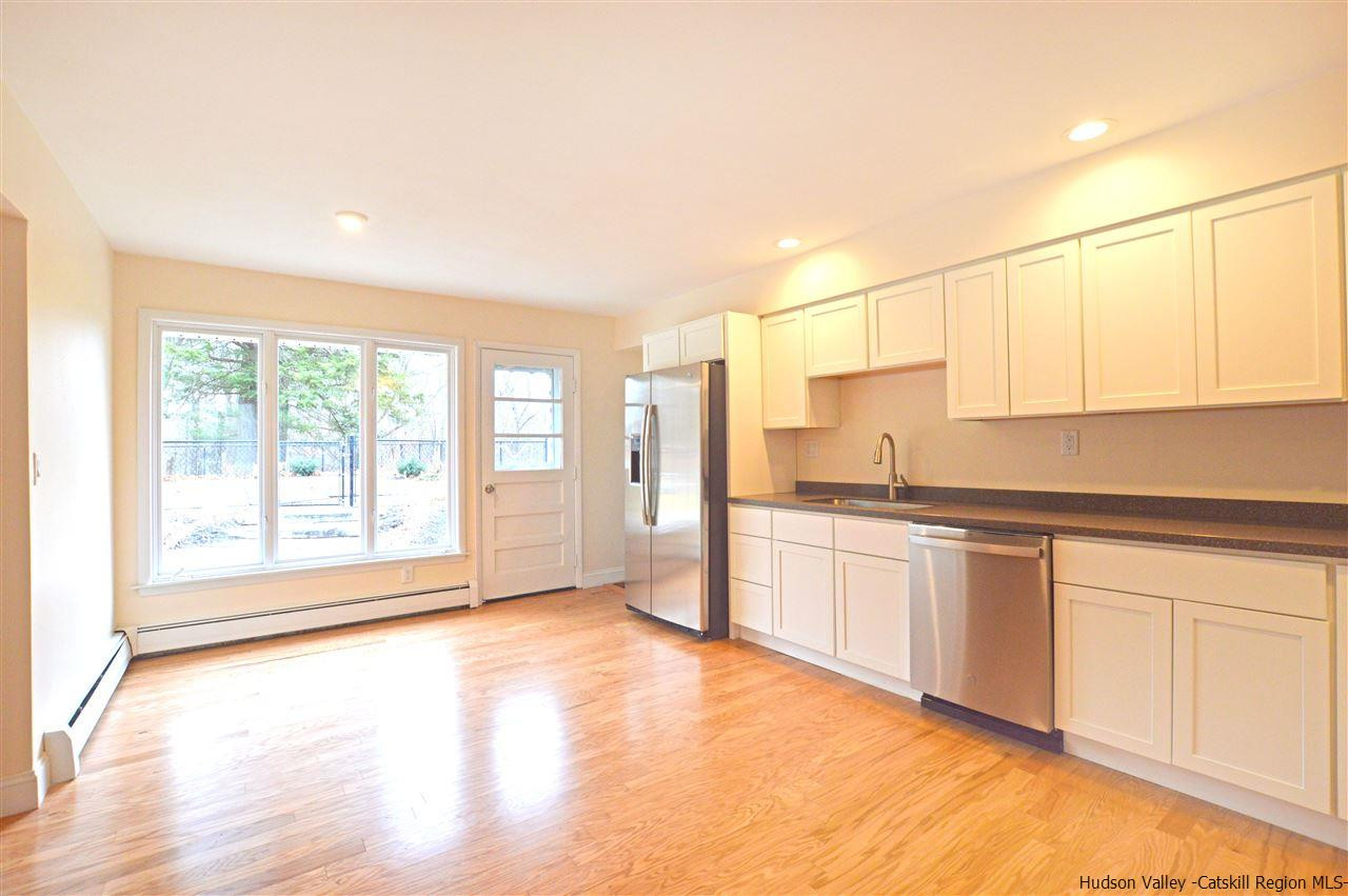47 Roxanne Boulevard Highland, NY 12528 - Photo 7 of 24 a open kitchen with granite countertop a sink and white cabinets with wooden floor