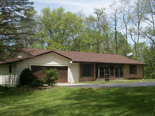 3398 North River Road Oregon, IL 61061 - Photo 1 of 11 a front view of a house with a garden