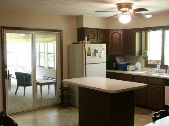 3398 North River Road Oregon, IL 61061 - Photo 5 of 11 a kitchen with a refrigerator a sink cabinets and wooden floor