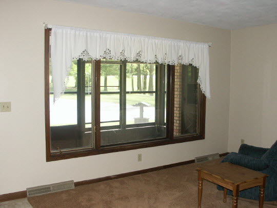 3398 North River Road Oregon, IL 61061 - Photo 6 of 11 a living room with a large window and a bed