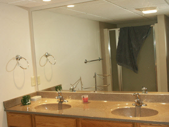 3398 North River Road Oregon, IL 61061 - Photo 7 of 11 a bathroom with a double vanity sink and a mirror