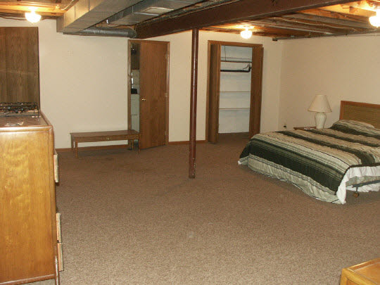 3398 North River Road Oregon, IL 61061 - Photo 8 of 11 a room with a bed and a flat tv screen