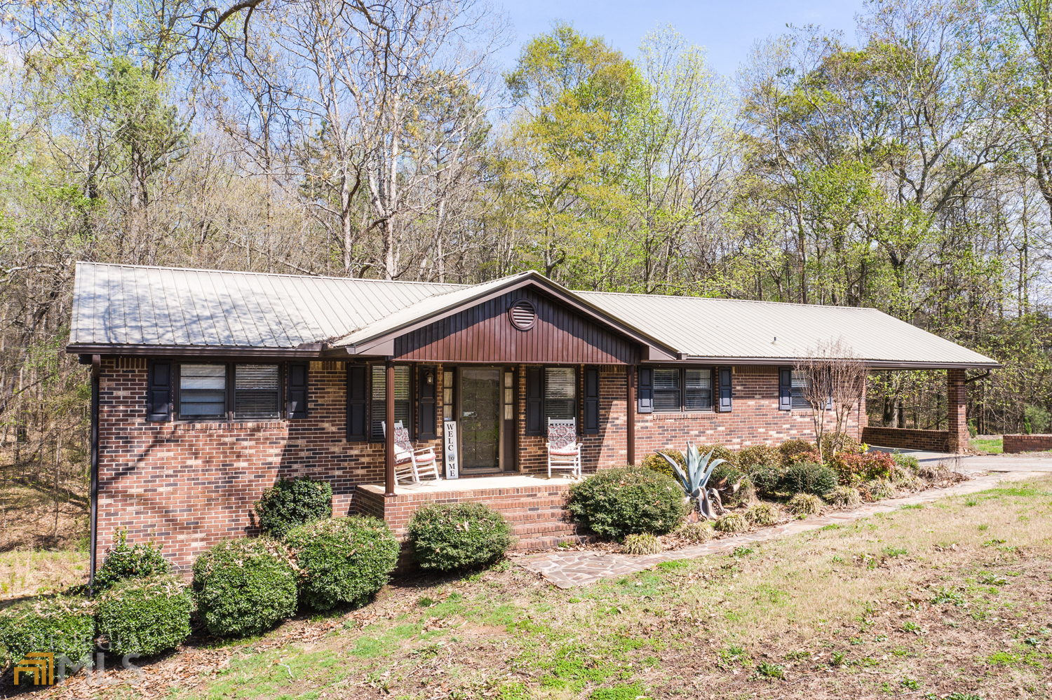 a front view of a house with yard and green space