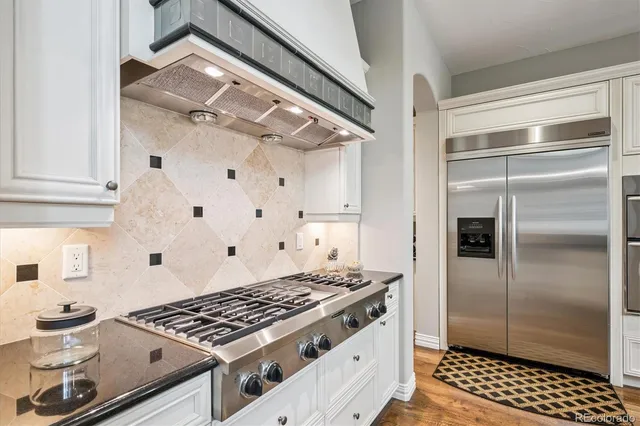 a stove top oven sitting inside of a kitchen
