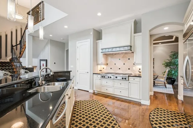 a kitchen with a sink a stove and cabinets