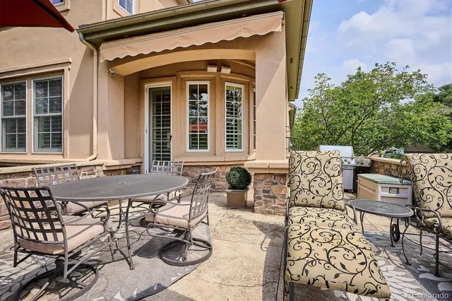 a view of a patio with table and chairs and potted plants
