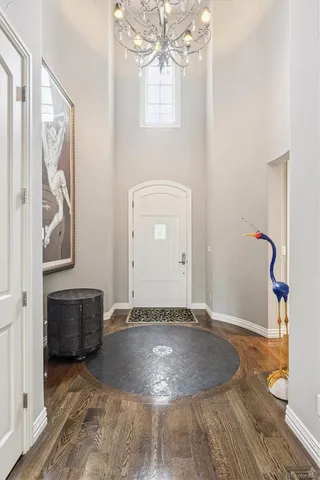 a view of a livingroom with wooden floor and staircase