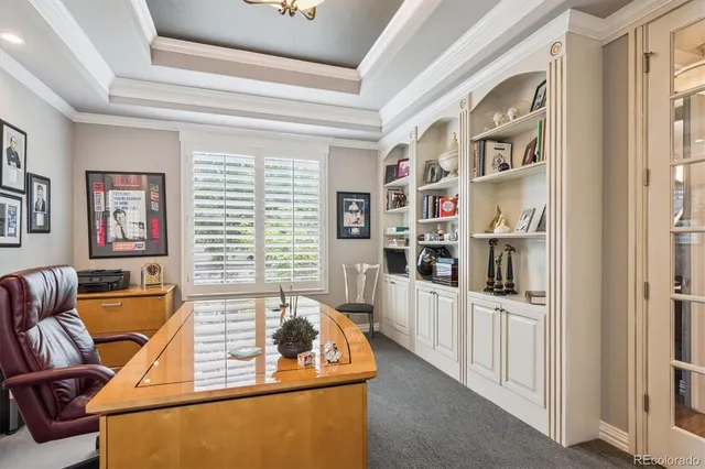 a living room with furniture cabinets and a window