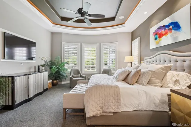 a bedroom with a large bed couch and a window