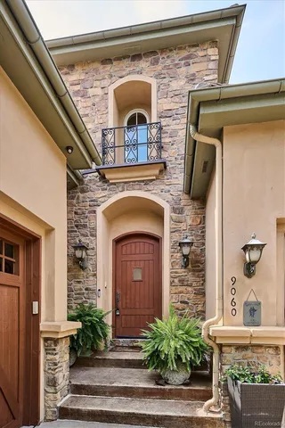 a front view of a house with plants