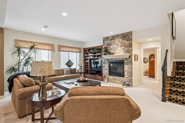 a living room with furniture a fireplace and a flat screen tv