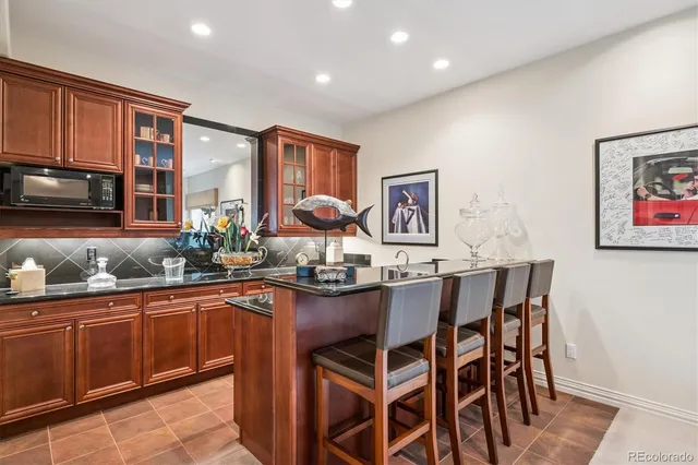 a dining table with chairs and cabinets