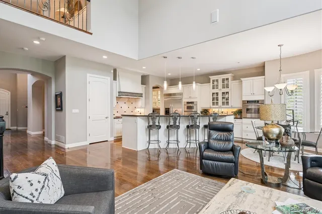 a living room with furniture and a chandelier