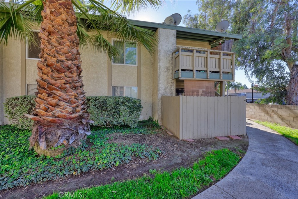 1800 East Old Ranch Road, Unit 148 Colton, CA 92324 - Photo 11 of 16 front view of a house with a yard and potted plants