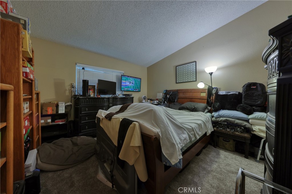 1800 East Old Ranch Road, Unit 148 Colton, CA 92324 - Photo 21 of 23 a bedroom with a bed and a couch