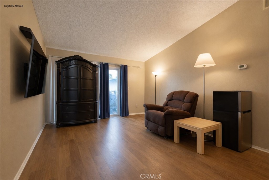 1800 East Old Ranch Road, Unit 148 Colton, CA 92324 - Photo 3 of 16 a living room with furniture and a flat screen tv