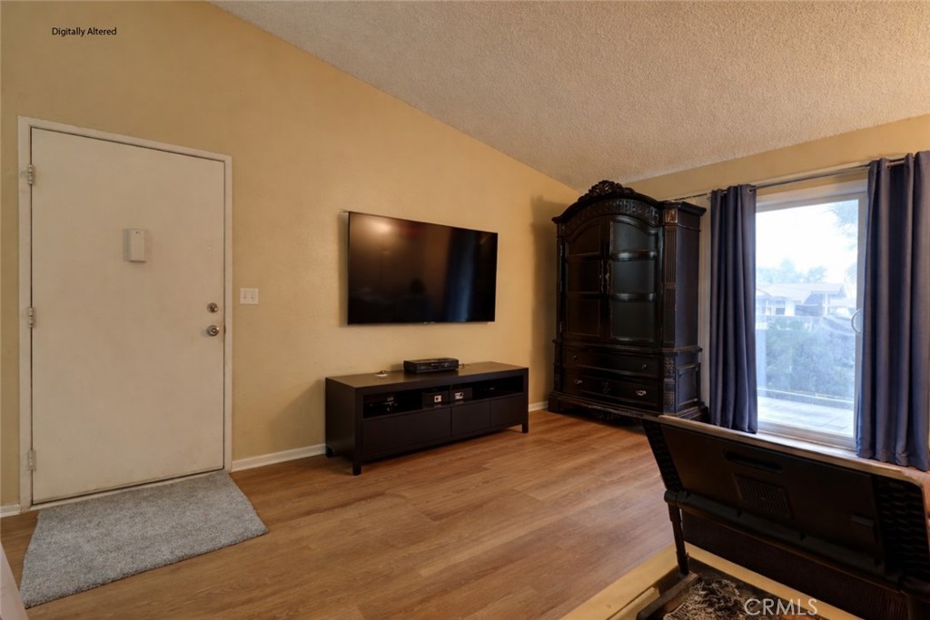 1800 East Old Ranch Road, Unit 148 Colton, CA 92324 - Photo 4 of 16 a bedroom with a bed and a flat tv screen on dresser