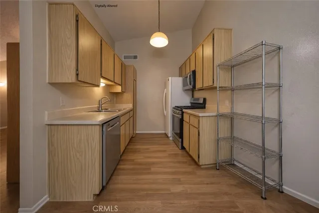 a kitchen with cabinets and steel appliances