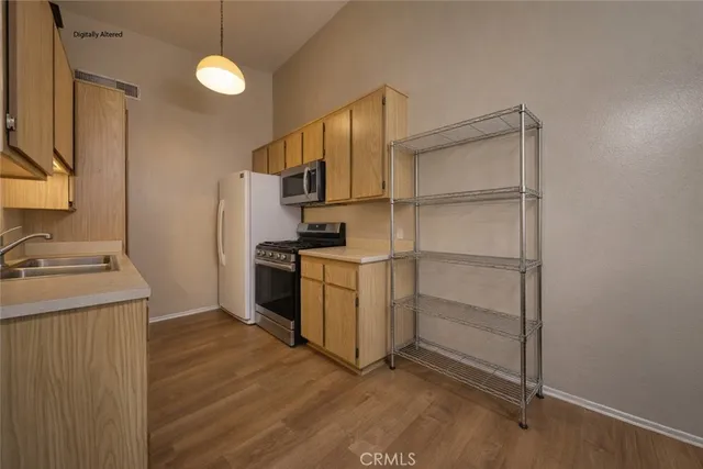 a view of room with a piano and wooden floor