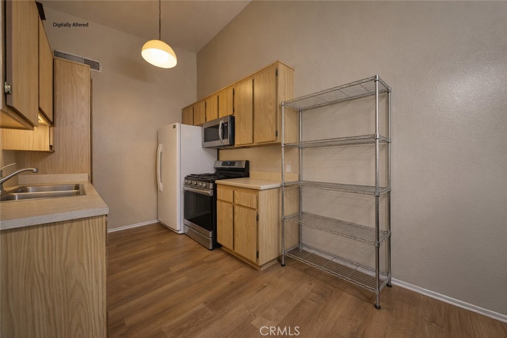 1800 East Old Ranch Road, Unit 148 Colton, CA 92324 - Photo 6 of 16 a kitchen with cabinets and steel appliances