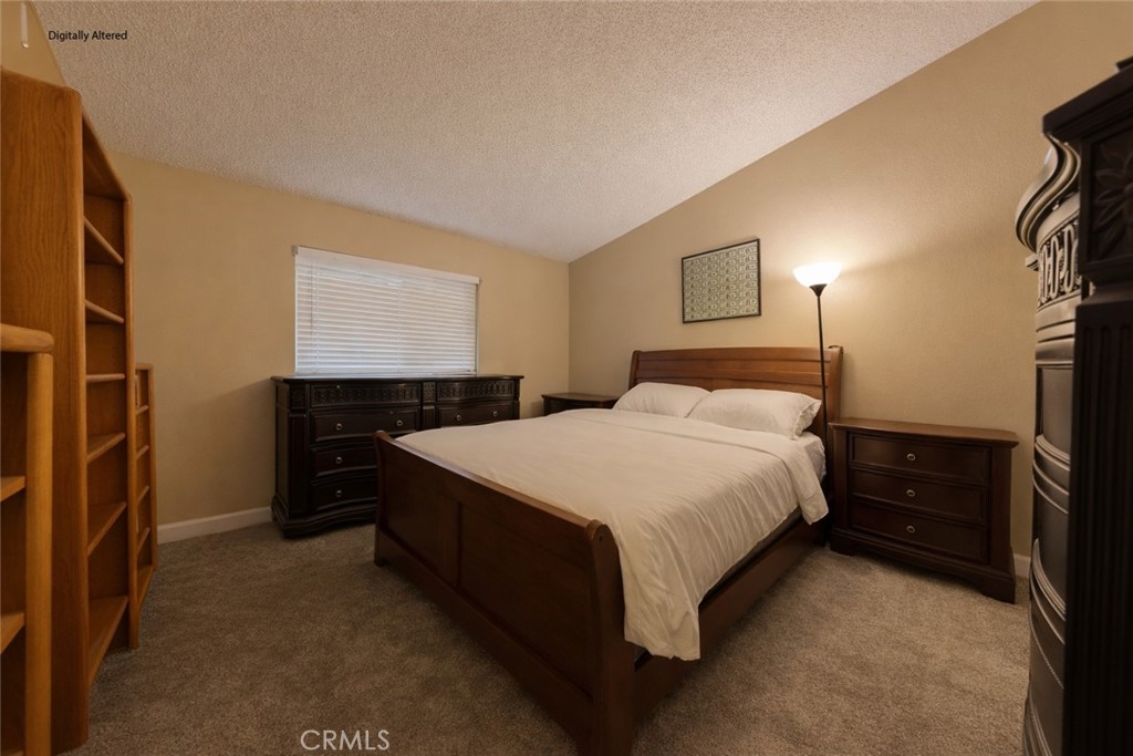 1800 East Old Ranch Road, Unit 148 Colton, CA 92324 - Photo 8 of 16 a bedroom with a bed and a night stand