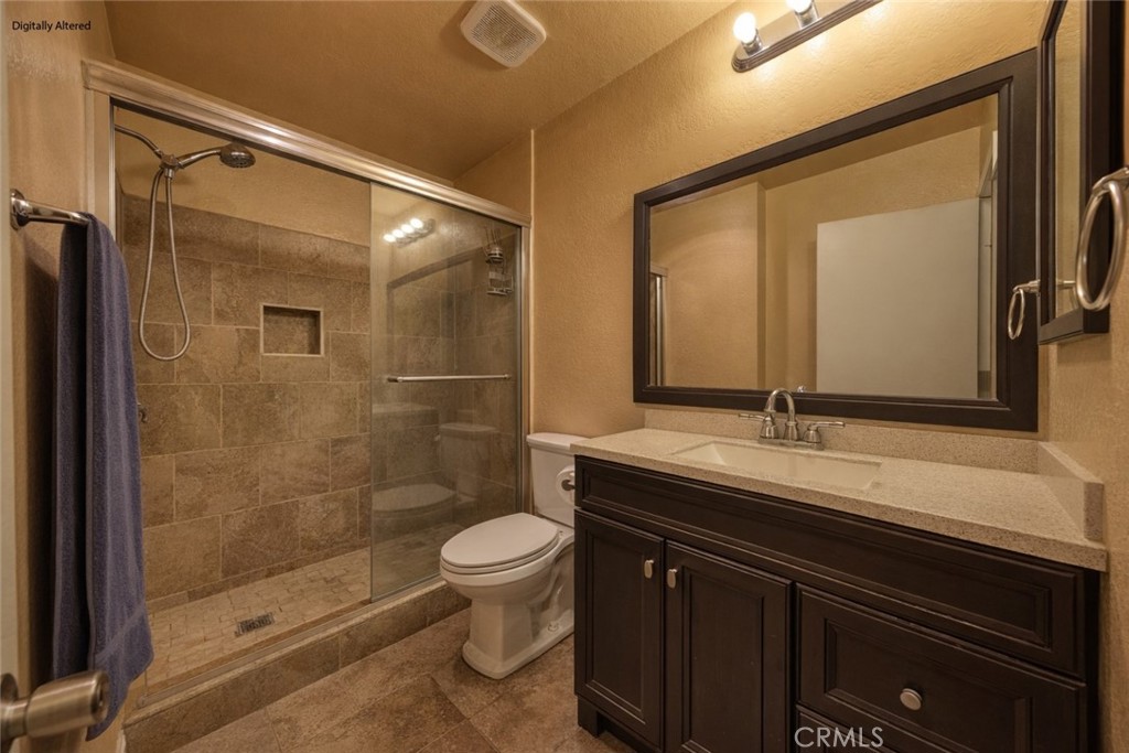 1800 East Old Ranch Road, Unit 148 Colton, CA 92324 - Photo 9 of 16 a bathroom with a sink a toilet and shower