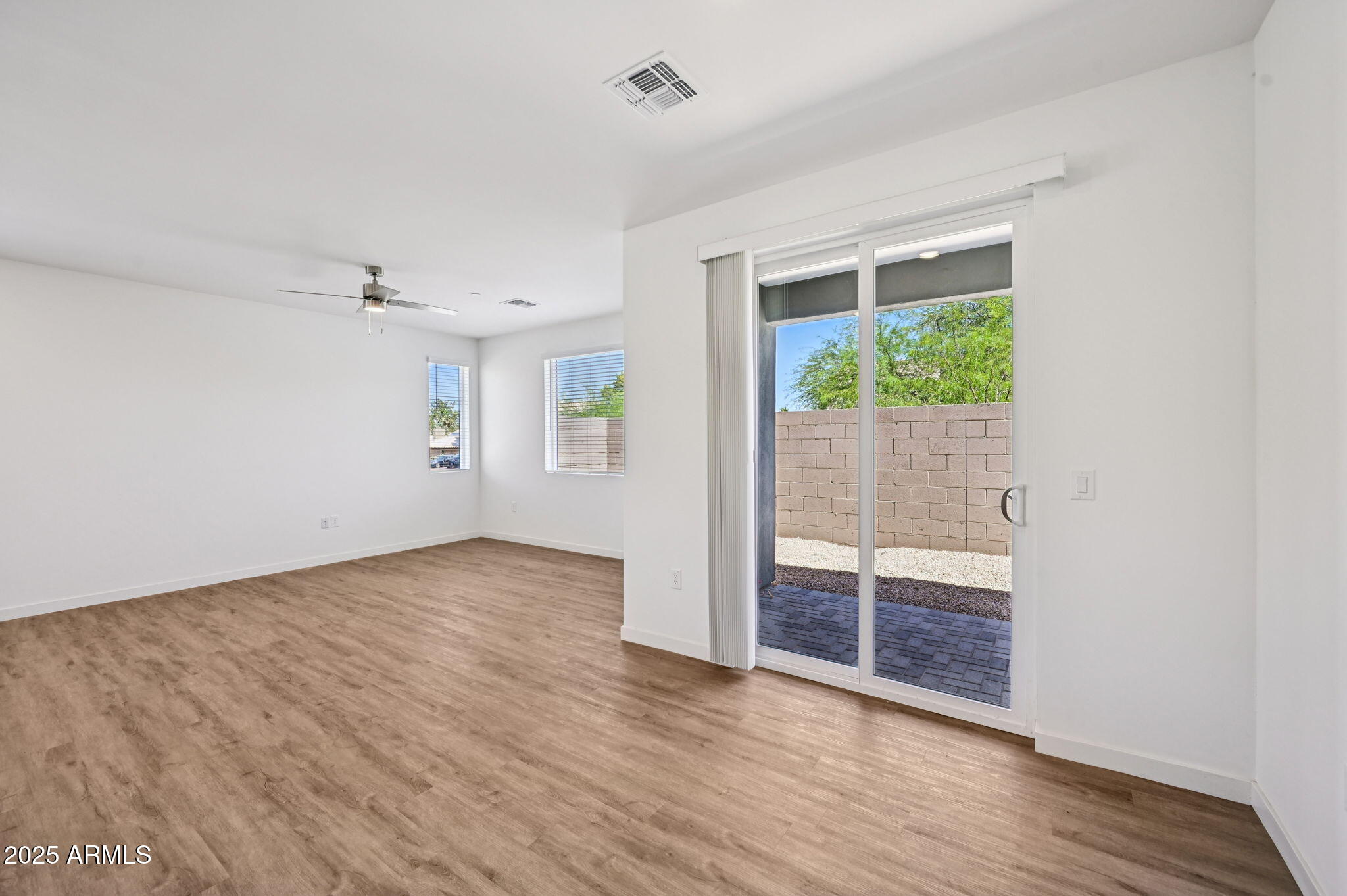 2131 East Jennifer Lynn Way Phoenix, AZ 85022 - Photo 11 of 45 an empty room with wooden floor and windows