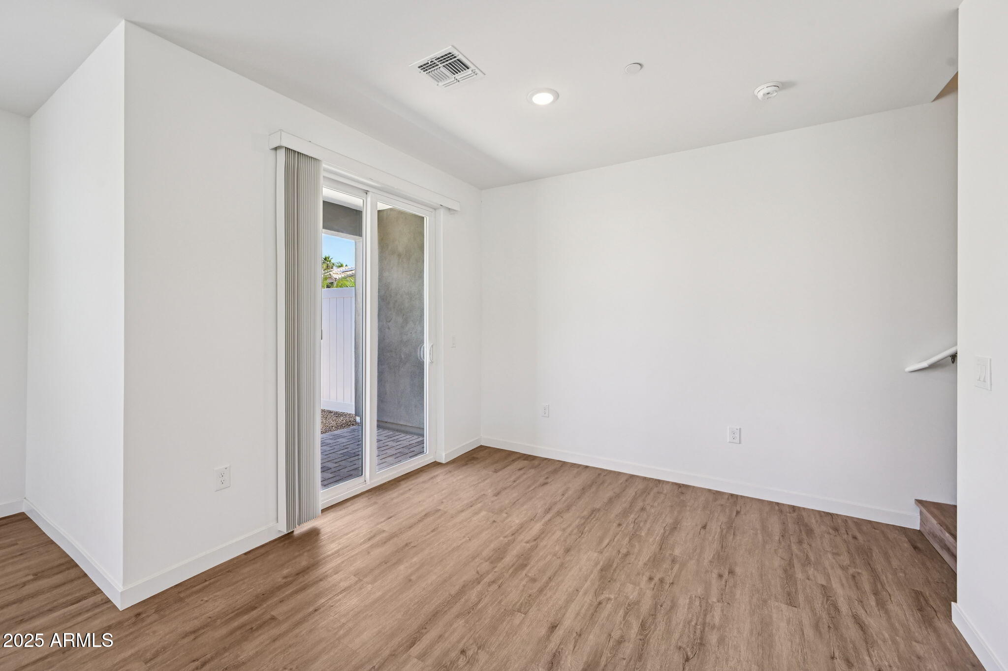 2131 East Jennifer Lynn Way Phoenix, AZ 85022 - Photo 12 of 45 a view of an empty room with wooden floor and closet