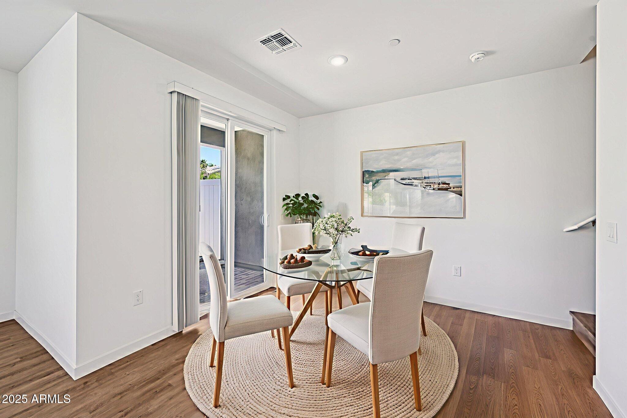 2131 East Jennifer Lynn Way Phoenix, AZ 85022 - Photo 13 of 45 a view of a dining room with furniture and wooden floor