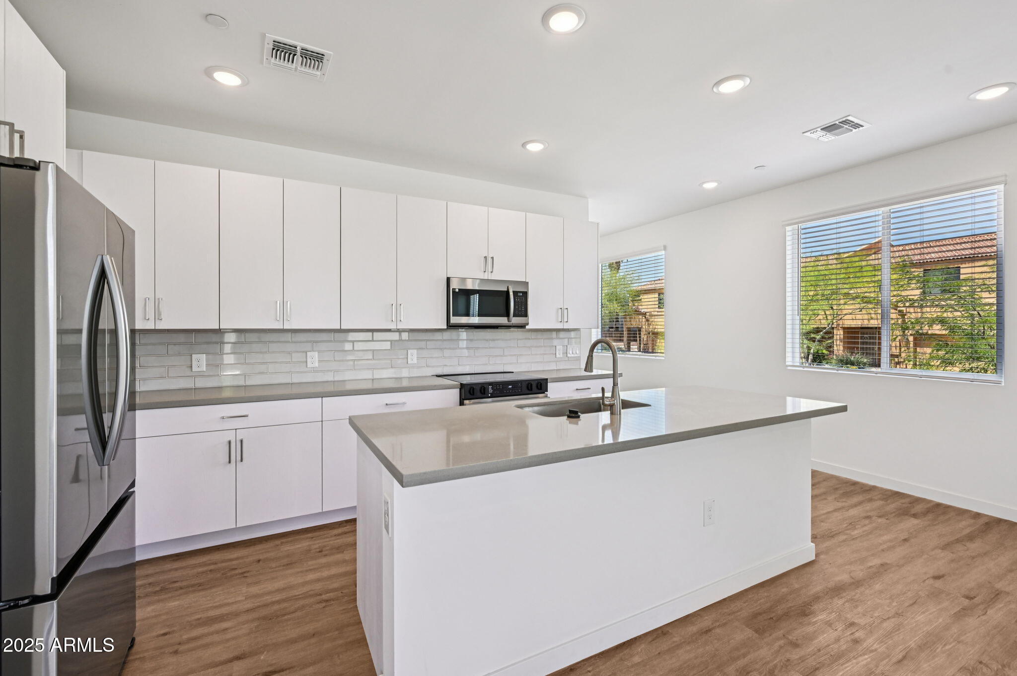 2131 East Jennifer Lynn Way Phoenix, AZ 85022 - Photo 19 of 45 a kitchen with stainless steel appliances granite countertop a sink a stove a refrigerator cabinets and a window