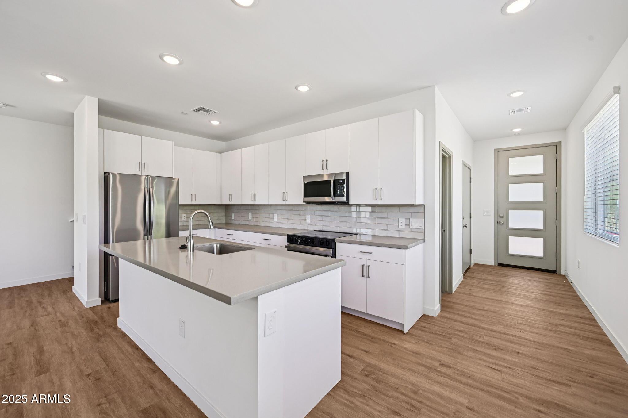 2131 East Jennifer Lynn Way Phoenix, AZ 85022 - Photo 20 of 45 a kitchen with white cabinets and stainless steel appliances