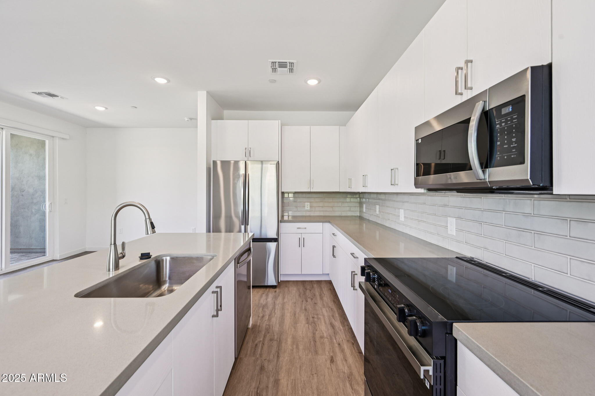 2131 East Jennifer Lynn Way Phoenix, AZ 85022 - Photo 23 of 45 a kitchen with a sink a stove and cabinets