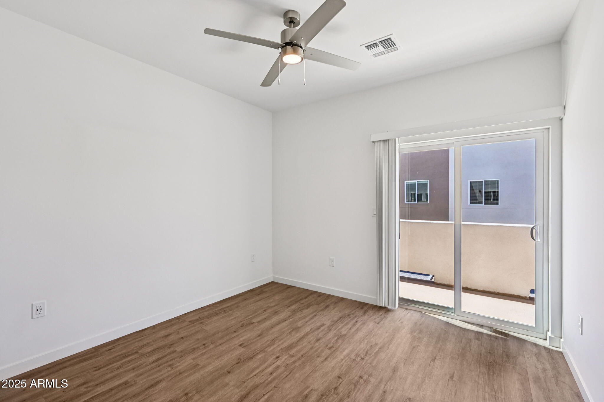 2131 East Jennifer Lynn Way Phoenix, AZ 85022 - Photo 30 of 45 an empty room with wooden floor and ceiling fan