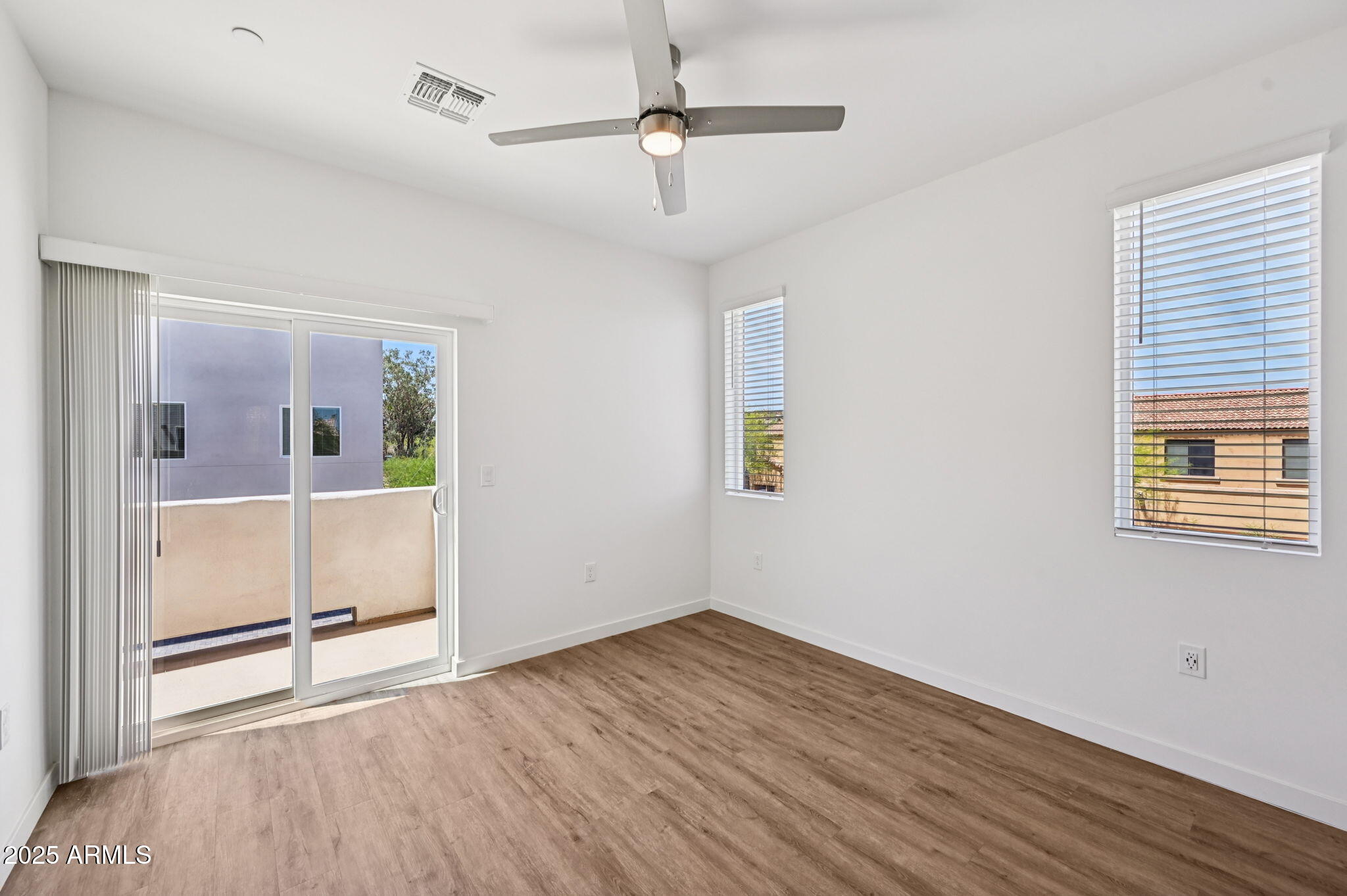 2131 East Jennifer Lynn Way Phoenix, AZ 85022 - Photo 33 of 45 a view of empty room with wooden floor and fan