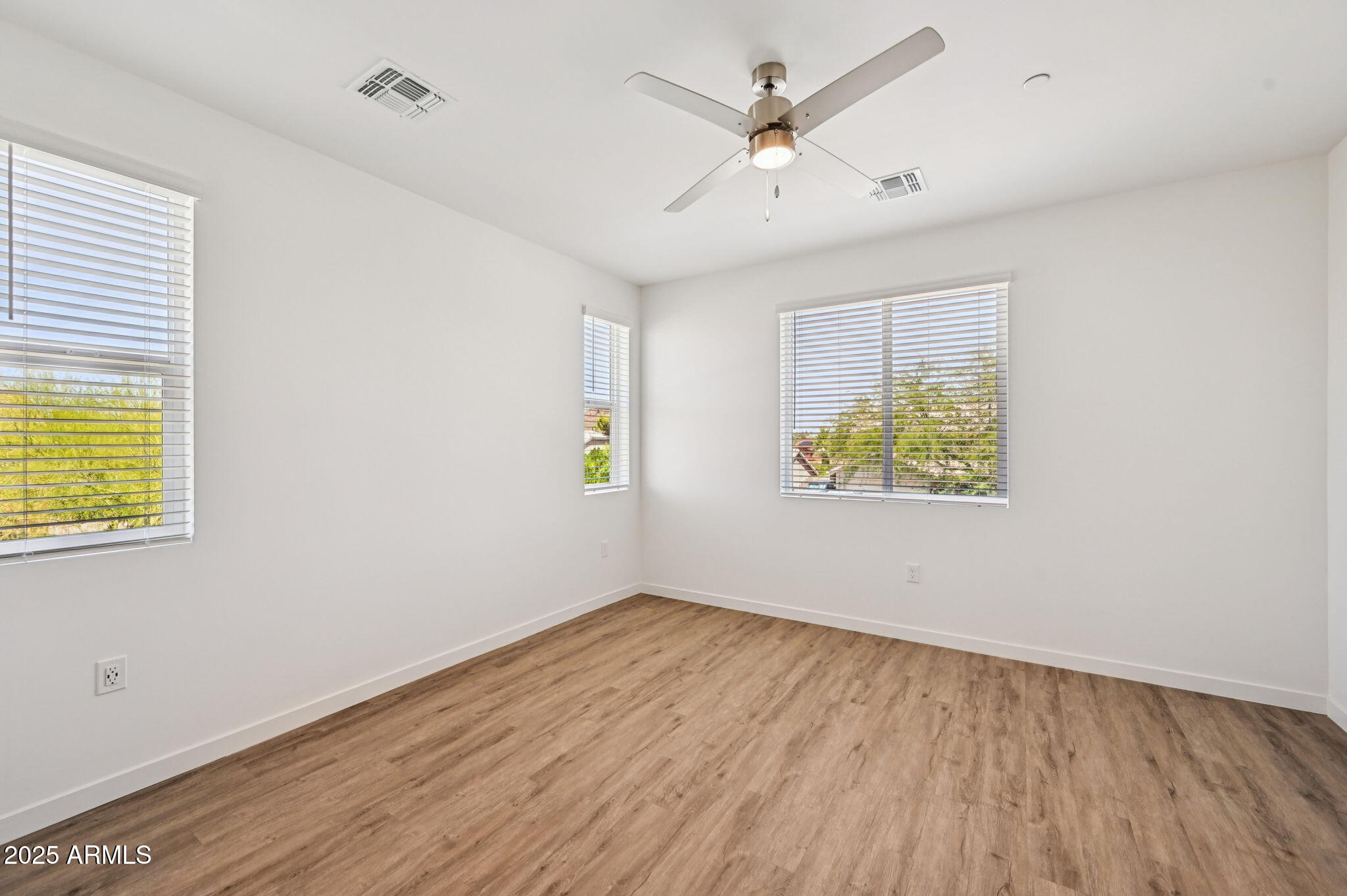 2131 East Jennifer Lynn Way Phoenix, AZ 85022 - Photo 6 of 45 wooden floor in an empty room with a window