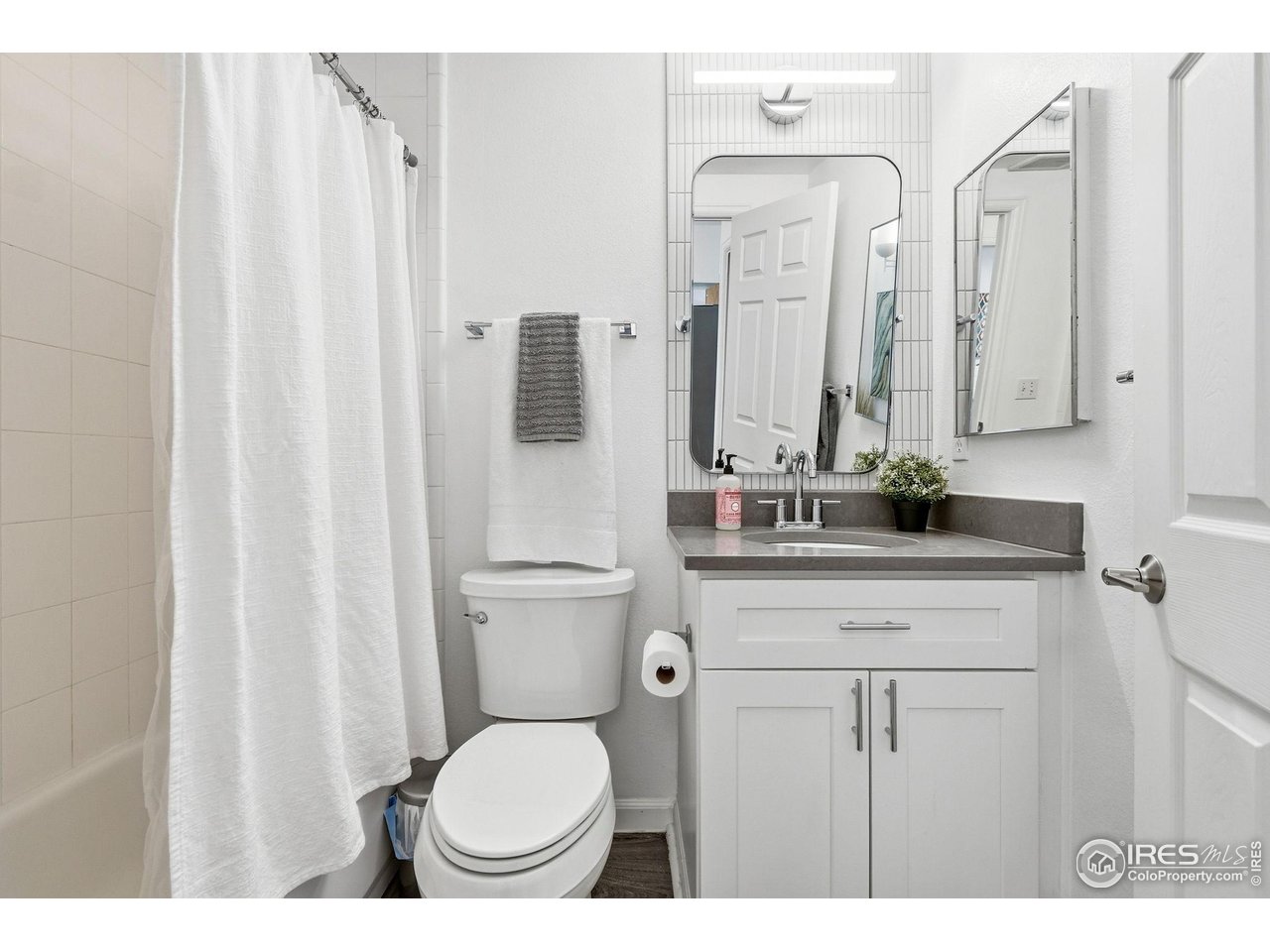 3077 29th Street, Unit 105 Boulder, CO 80301 - Photo 11 of 27 a bathroom with a toilet a sink and a mirror