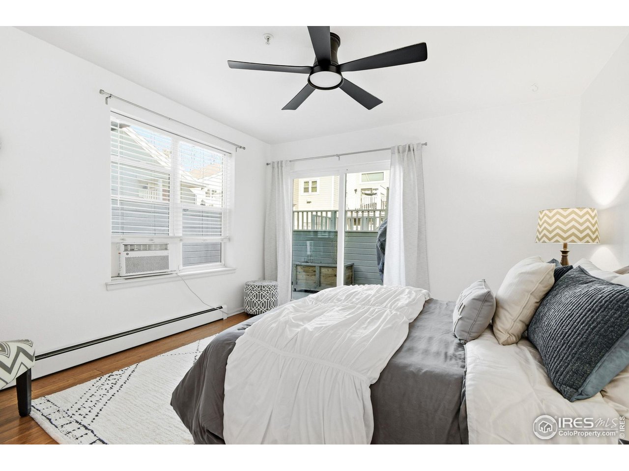 3077 29th Street, Unit 105 Boulder, CO 80301 - Photo 16 of 27 a bedroom with a bed and a window
